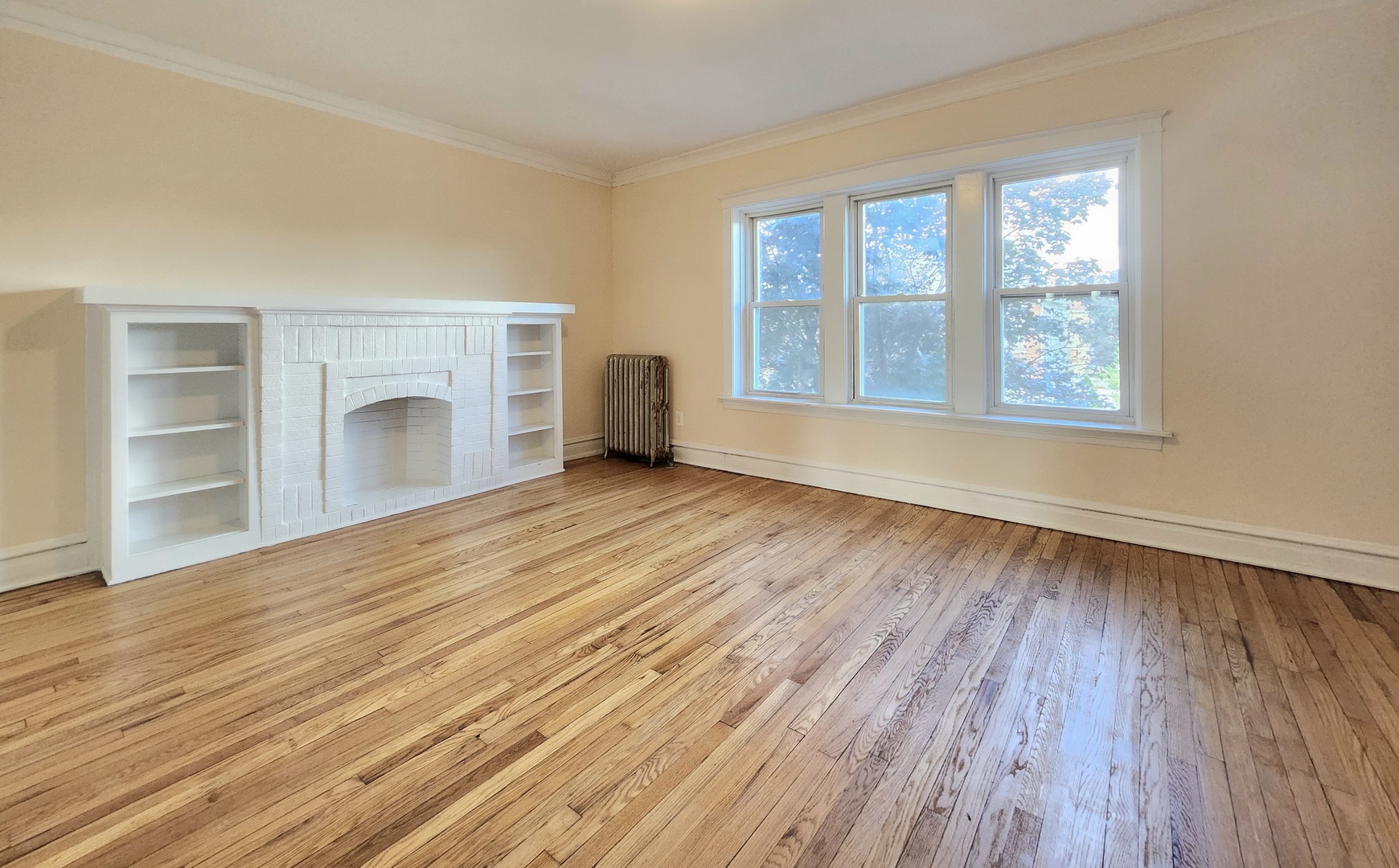 4937 West 18th Street, Unit 2W Cicero, IL 60804 - Photo 7 of 11 a view of an empty room with a window and wooden floor