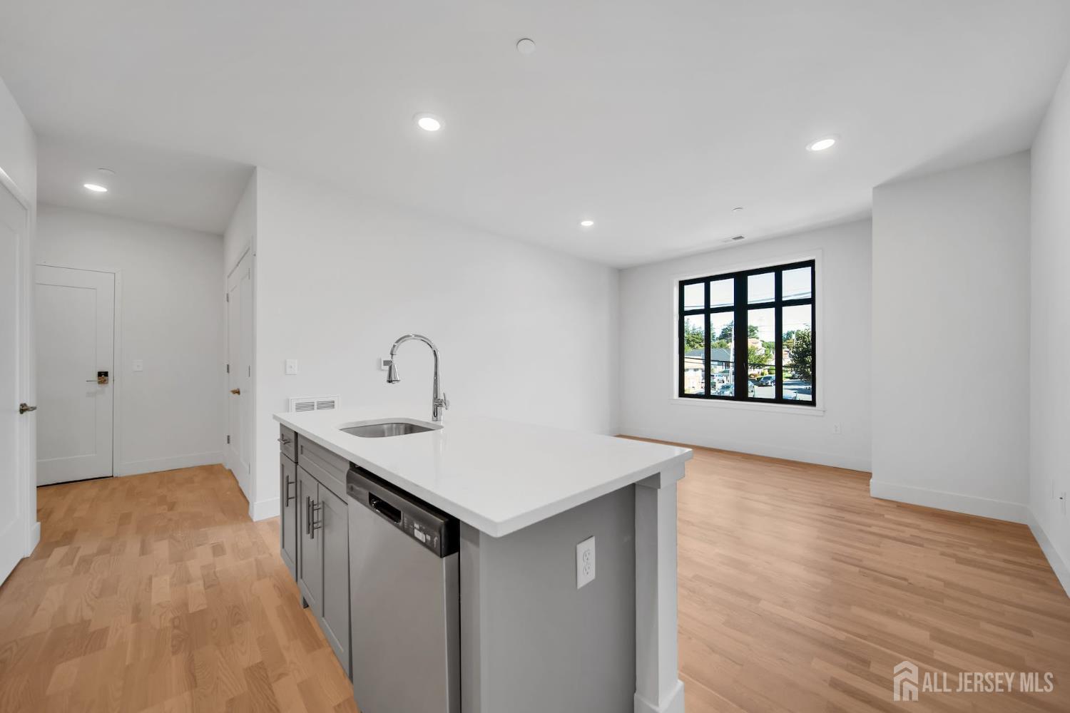1037 Amboy Avenue Edison, NJ 08837 - Photo 4 of 5 a view of a kitchen with a sink dishwasher and wooden floor
