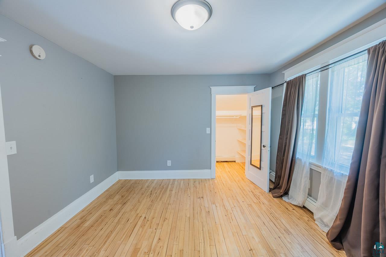 508 10th Street South Virginia, MN 55792 - Photo 17 of 43 Hardwood flooring throughout, neutral gray wall tones, and white trim