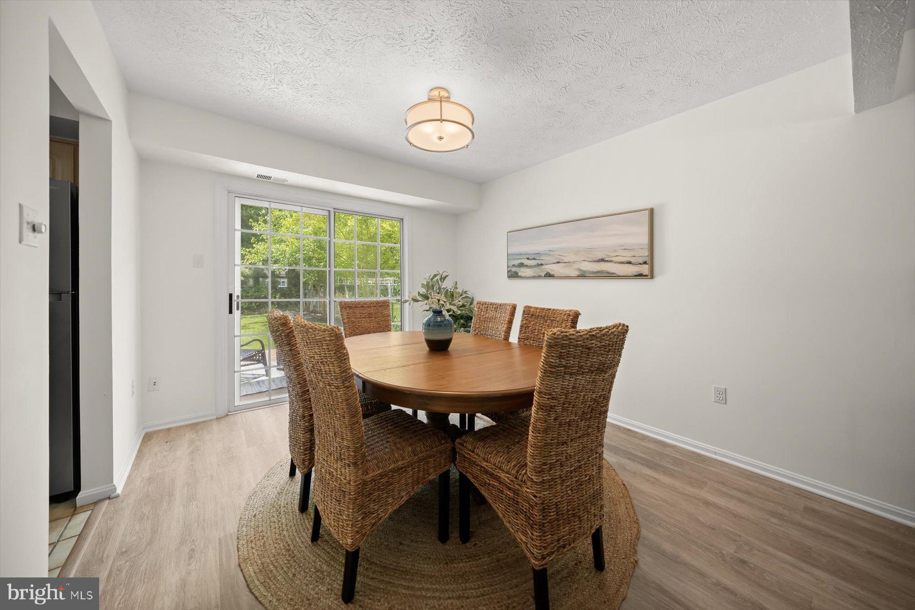 6819 Ben Franklin Road Springfield, VA 22150 - Photo 15 of 47 a view of a dining room with furniture window and wooden floor