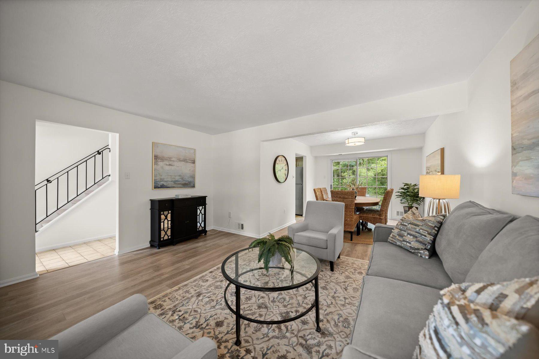 6819 Ben Franklin Road Springfield, VA 22150 - Photo 23 of 47 a living room with furniture a fireplace and a potted plant