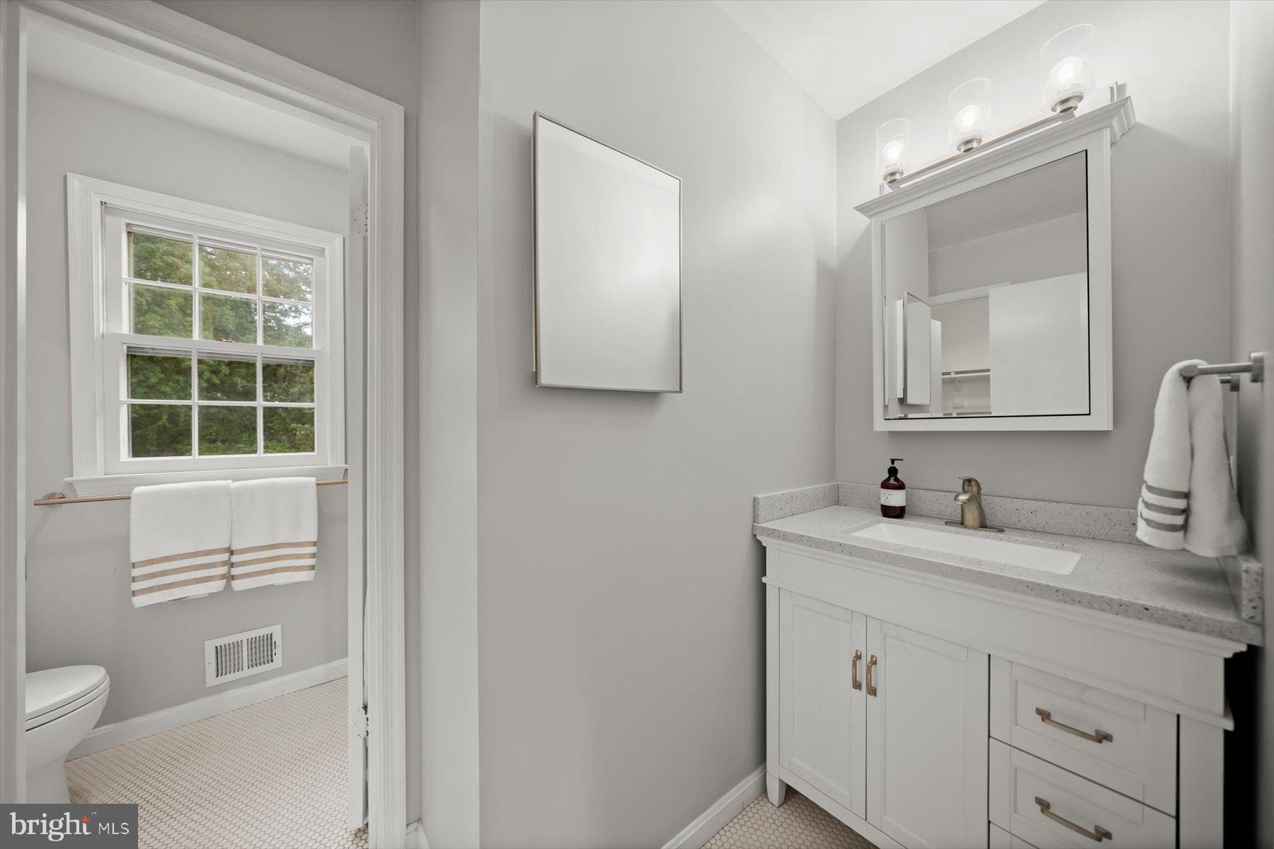 6819 Ben Franklin Road Springfield, VA 22150 - Photo 27 of 47 a bathroom with a toilet sink and mirror