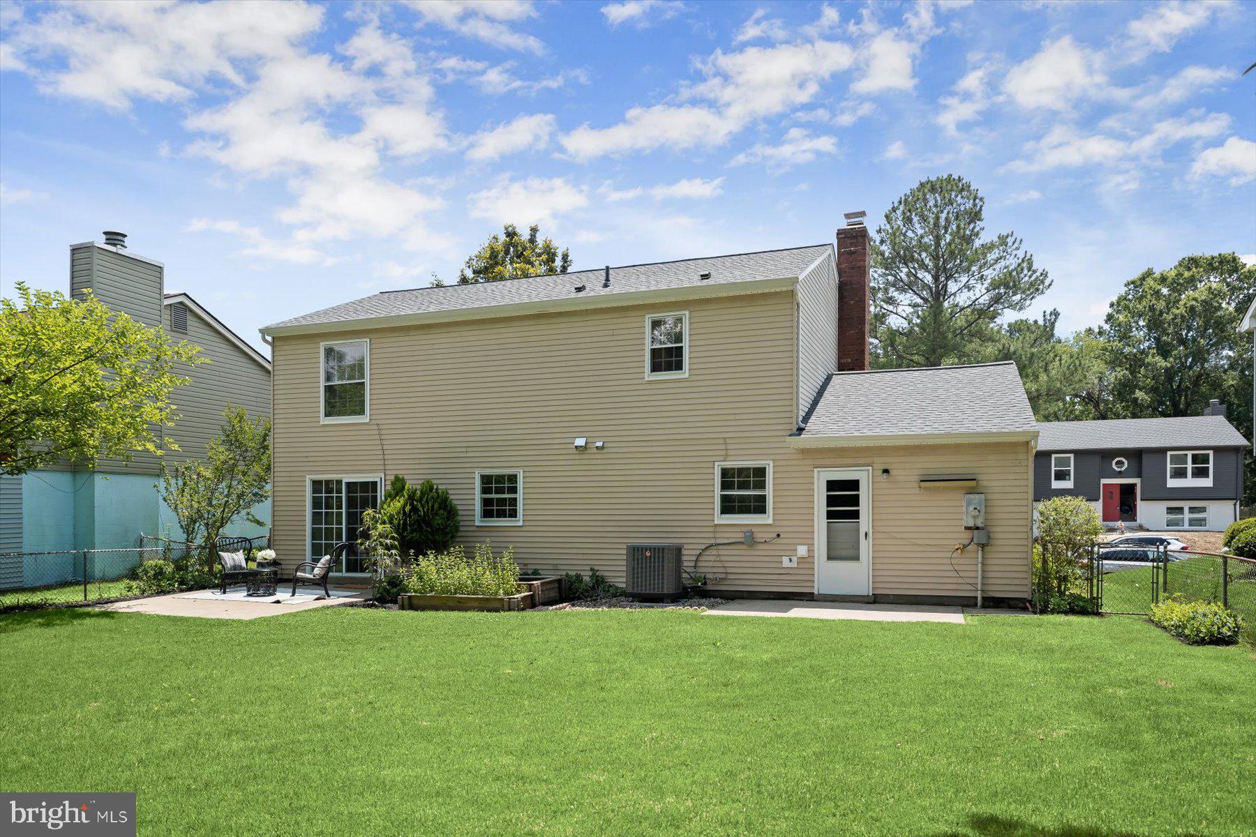 6819 Ben Franklin Road Springfield, VA 22150 - Photo 44 of 47 a front view of a house with a garden