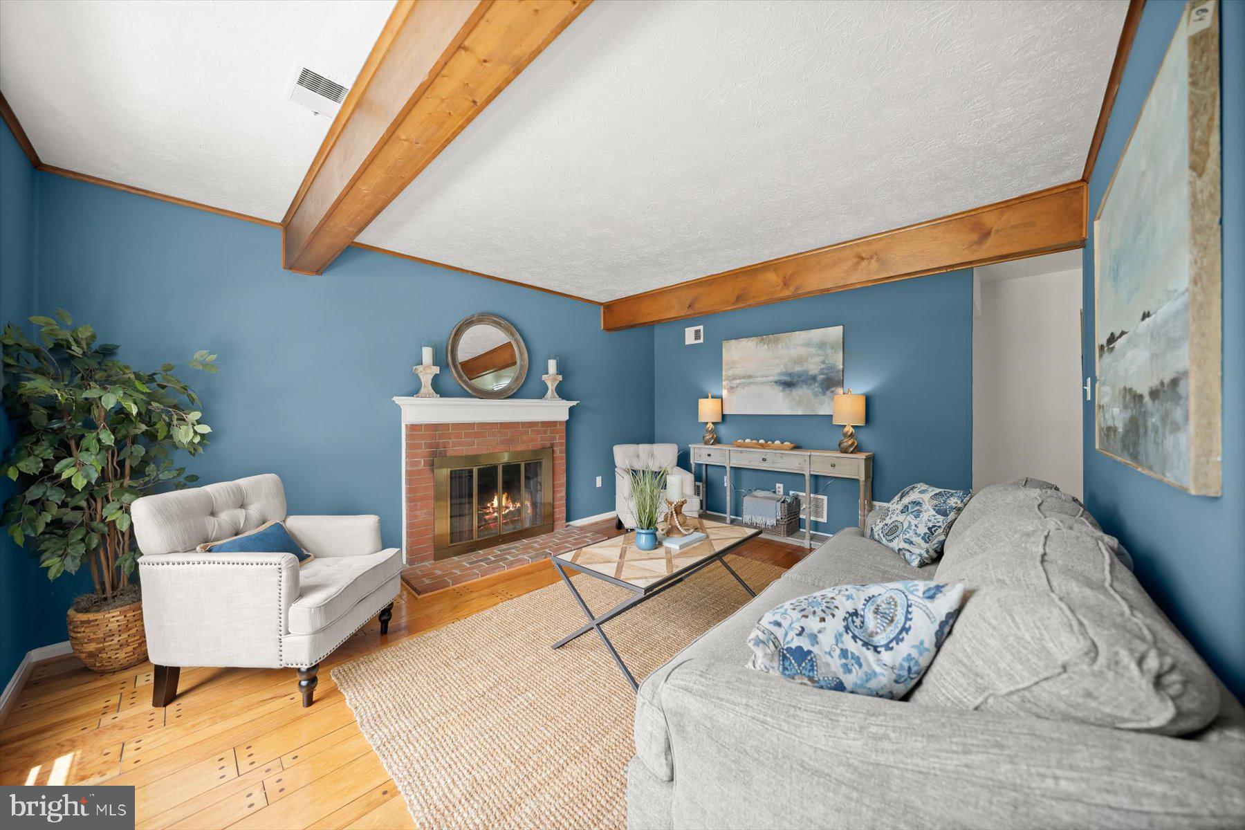 6819 Ben Franklin Road Springfield, VA 22150 - Photo 7 of 47 a living room with furniture a fireplace and potted plant