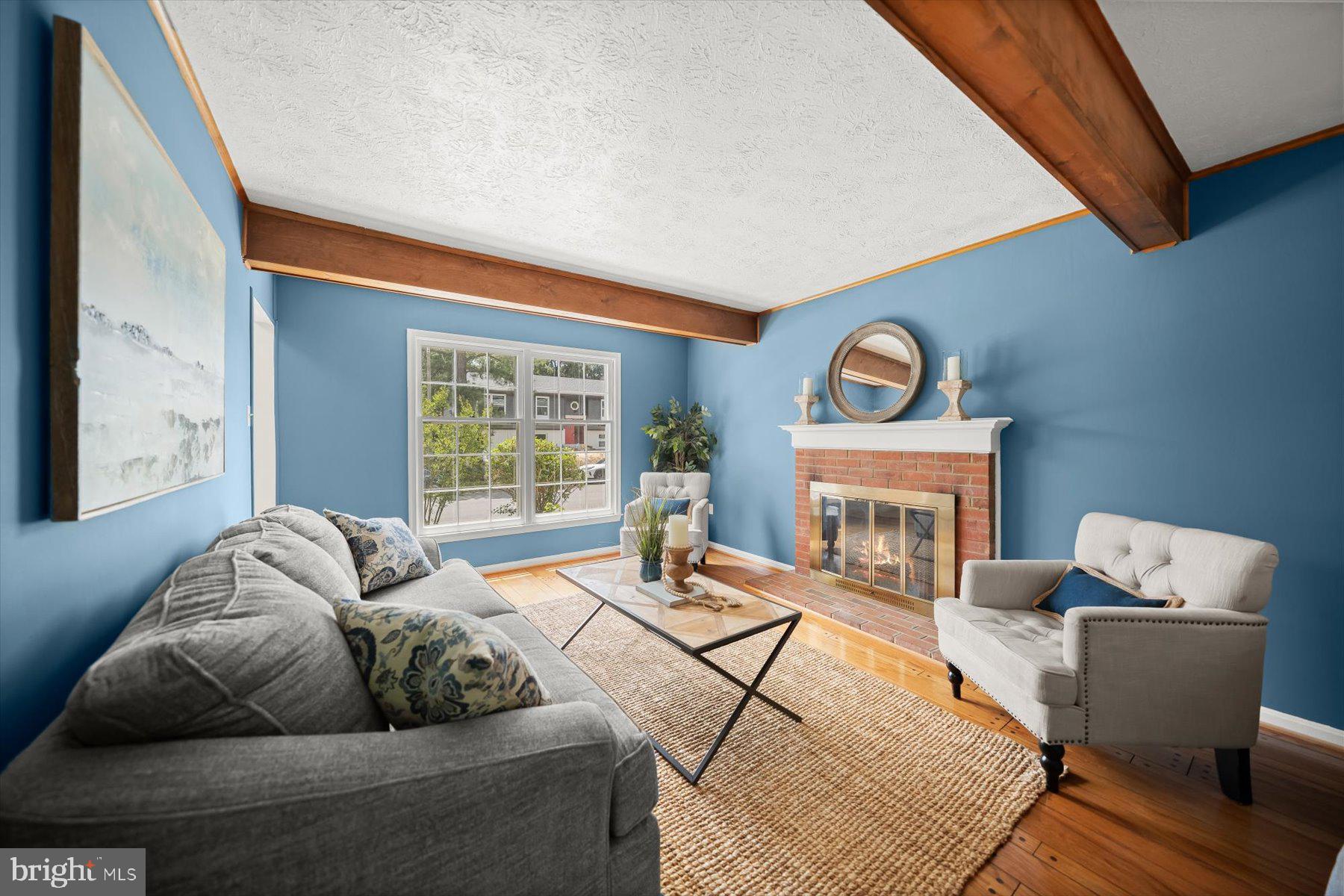 6819 Ben Franklin Road Springfield, VA 22150 - Photo 8 of 47 a living room with furniture and a fireplace