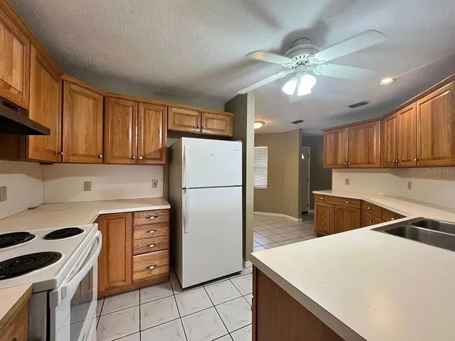 a view of a kitchen with furniture and an empty room