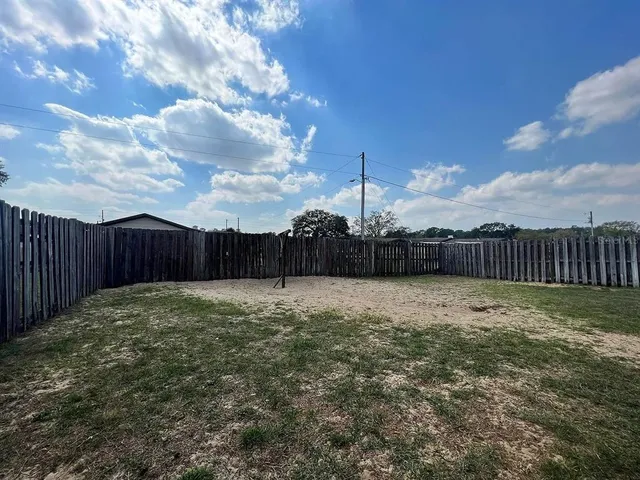 a kitchen with stainless steel appliances granite countertop a sink a stove a refrigerator a center island and cabinets