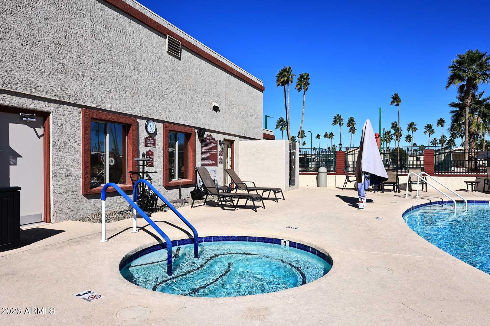 9302 East Broadway Road, Unit 76 Mesa, AZ 85208 - Photo 12 of 38 a view of swimming pool with outdoor seating