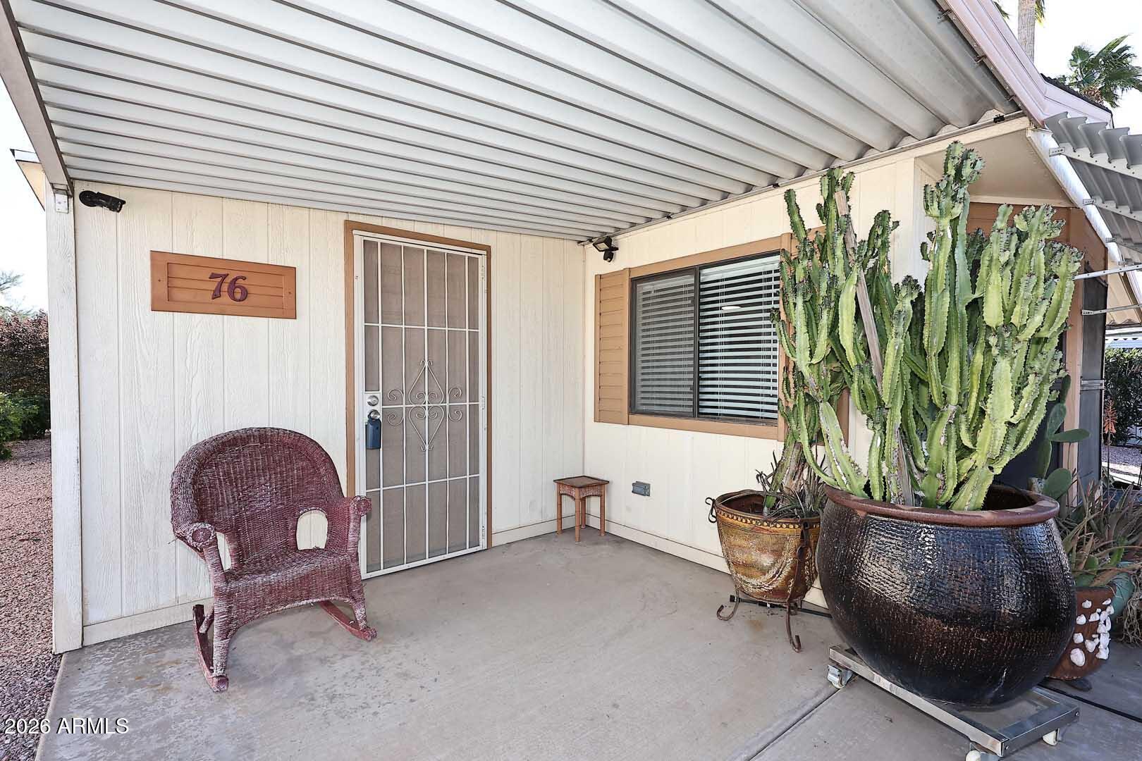 9302 East Broadway Road, Unit 76 Mesa, AZ 85208 - Photo 13 of 38 a living room filled with furniture and a potted plant