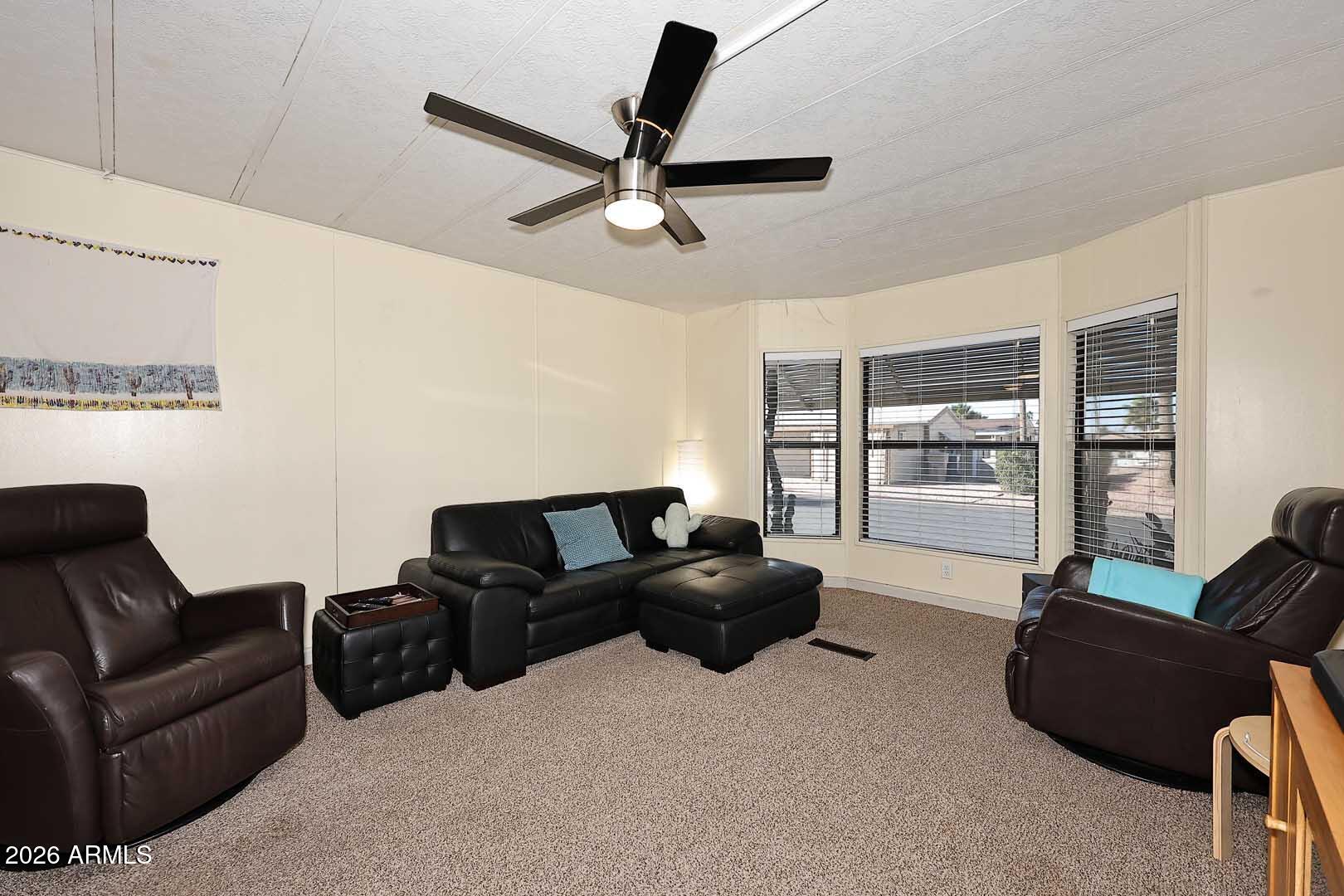9302 East Broadway Road, Unit 76 Mesa, AZ 85208 - Photo 2 of 38 a living room with furniture