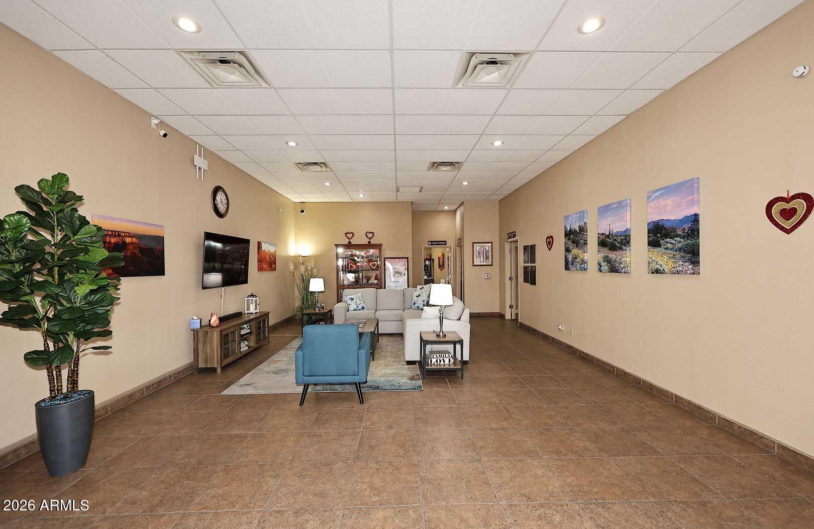 9302 East Broadway Road, Unit 76 Mesa, AZ 85208 - Photo 25 of 38 a view of a livingroom with furniture and a flat screen tv