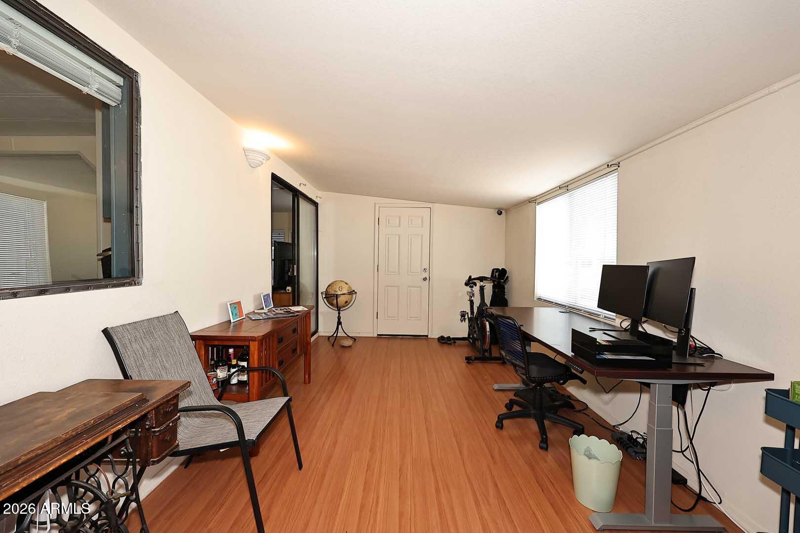 9302 East Broadway Road, Unit 76 Mesa, AZ 85208 - Photo 29 of 38 a view of a workspace with furniture and wooden floor