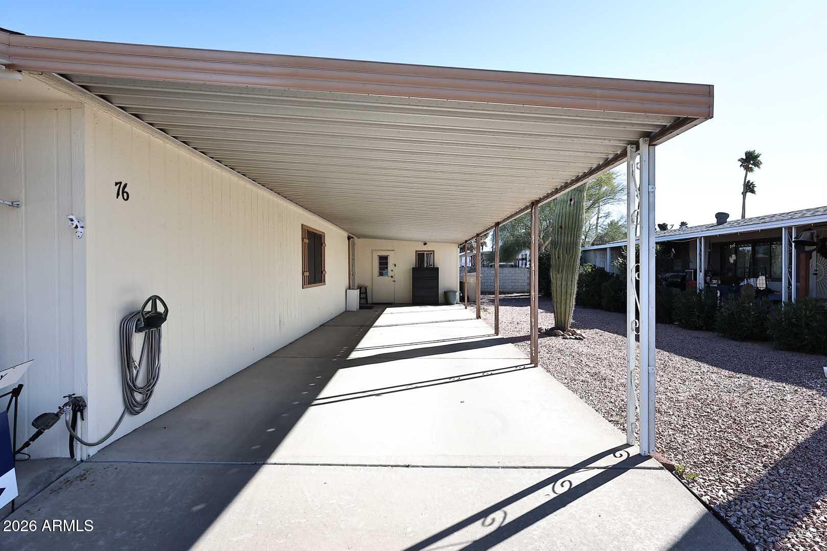 9302 East Broadway Road, Unit 76 Mesa, AZ 85208 - Photo 36 of 38 a view of a patio with table and chairs