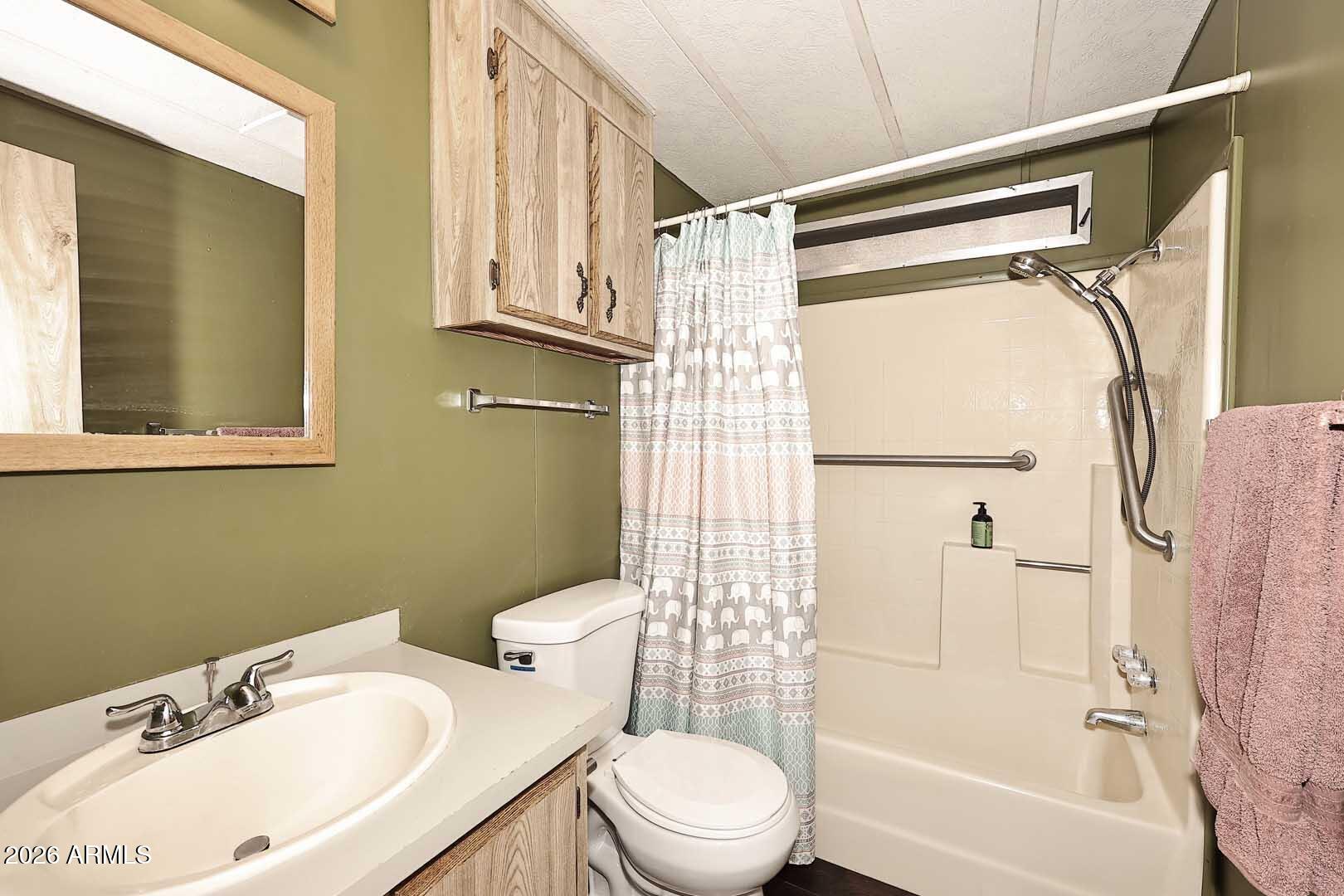 9302 East Broadway Road, Unit 76 Mesa, AZ 85208 - Photo 5 of 38 a bathroom with a sink toilet and shower