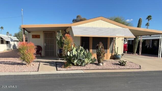 9302 East Broadway Road, Unit 76 Mesa, AZ 85208 - Photo 6 of 38 a view of a living room with a porch