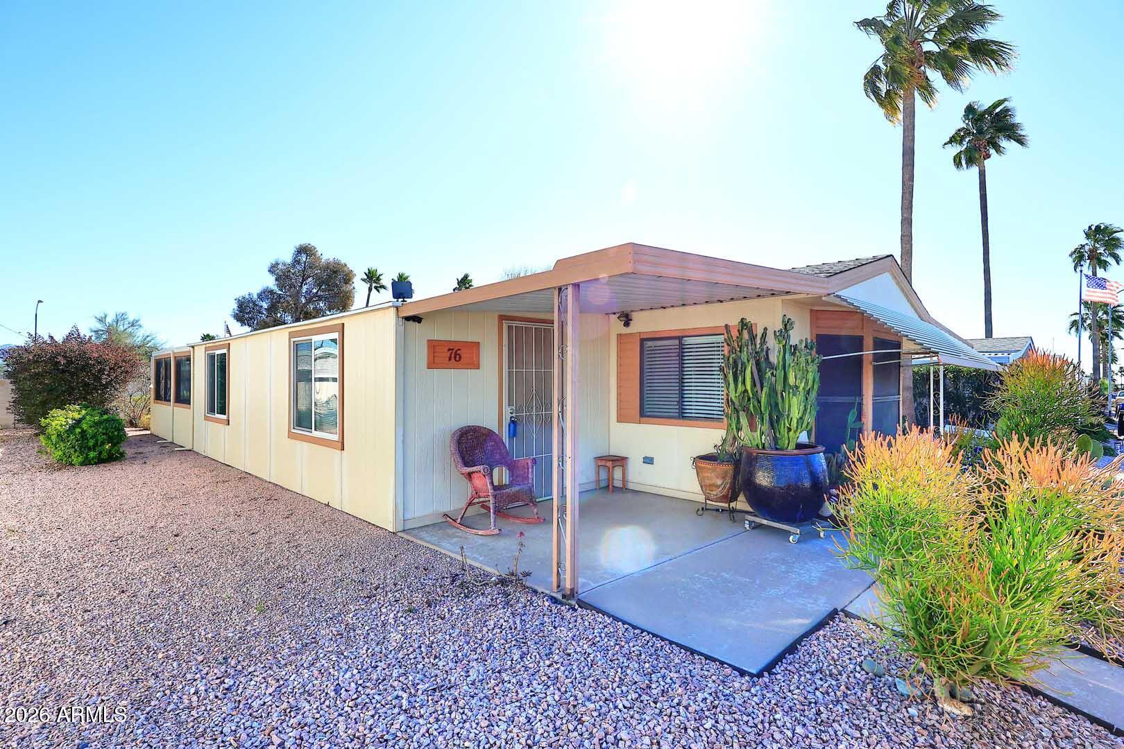 9302 East Broadway Road, Unit 76 Mesa, AZ 85208 - Photo 9 of 38 a front view of house with yard and trees around