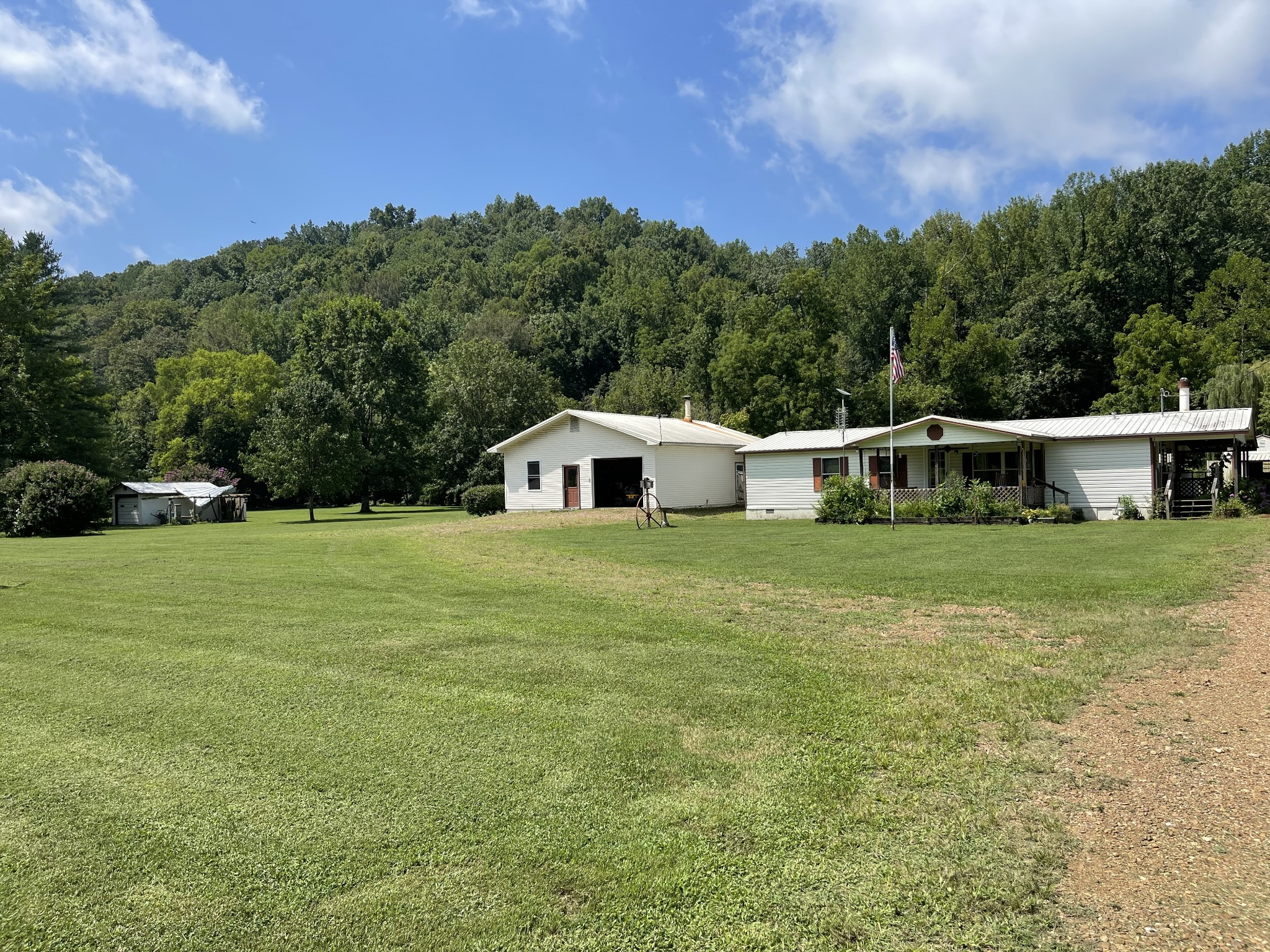 2330 Dog Branch Road Prospect, TN 38477 - Photo 2 of 31 a white house with a big yard and large trees