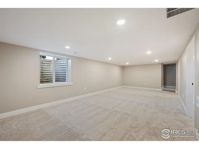 a bathroom with a sink a toilet a mirror and shower
