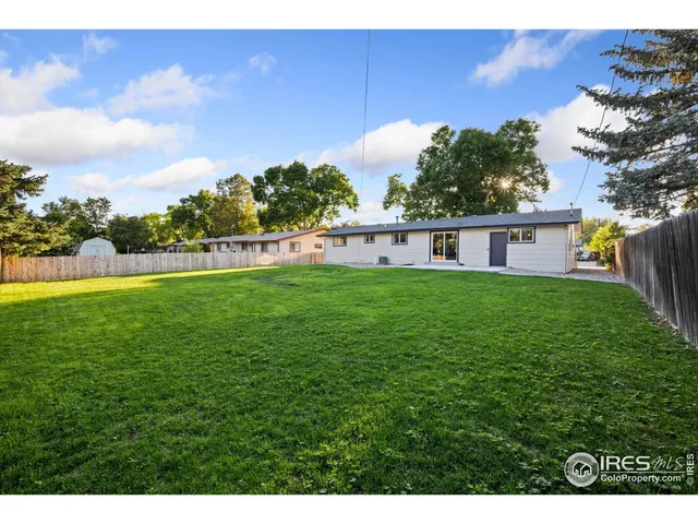 a view of a livingroom with a ceiling fan and wooden floor