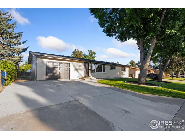 a view of house with swimming pool and a yard