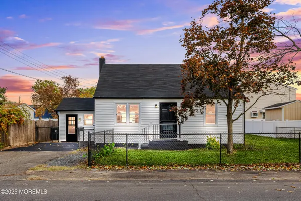 a front view of a house with a garden and plants