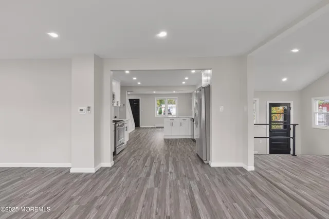 a view of a storage & utility room with a fridge