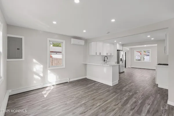 a view of entryway and hall with wooden floor