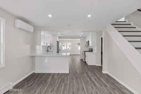 a view of room with window and wooden floor