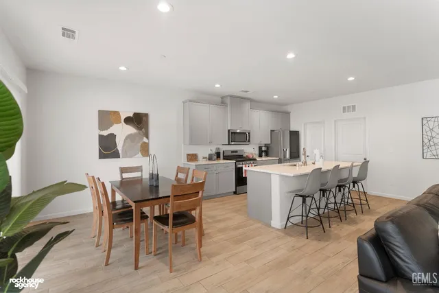 a large kitchen with a table and chairs