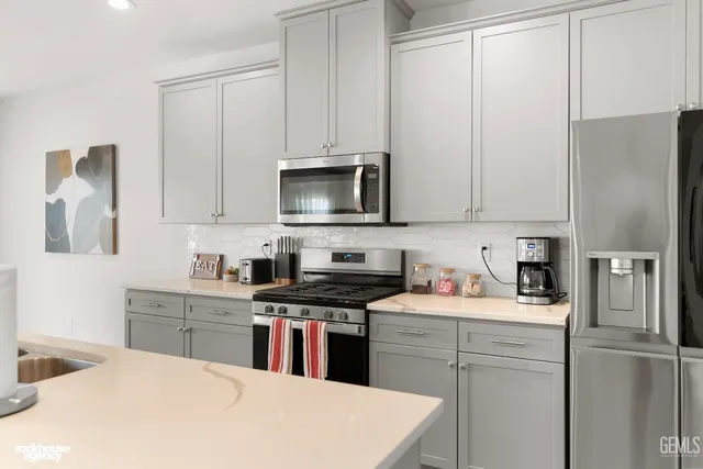 a kitchen with granite countertop lots of counter top space and stainless steel appliances