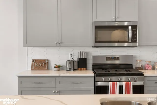 a spacious bedroom with a bed and a chandelier