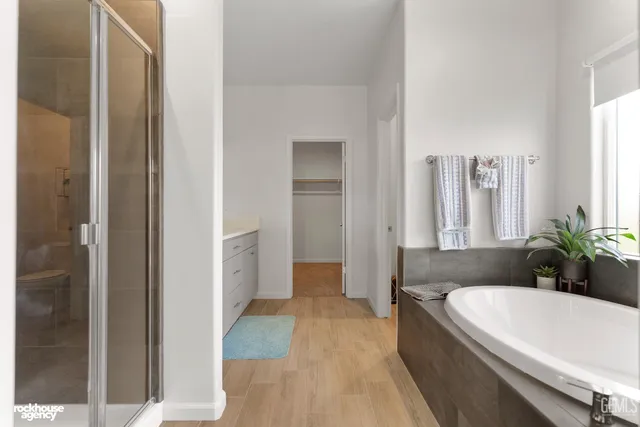a bathroom with a double vanity sink a mirror and a shower