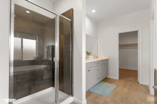 a bathroom with a granite countertop sink and a bathtub