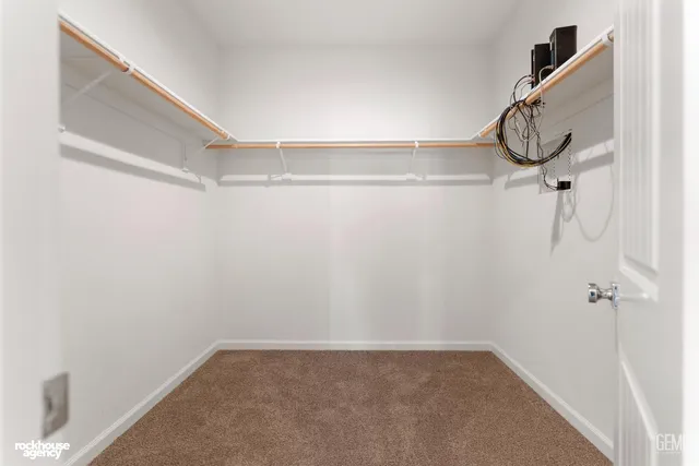 a spacious bathroom with a double vanity sink and a mirror