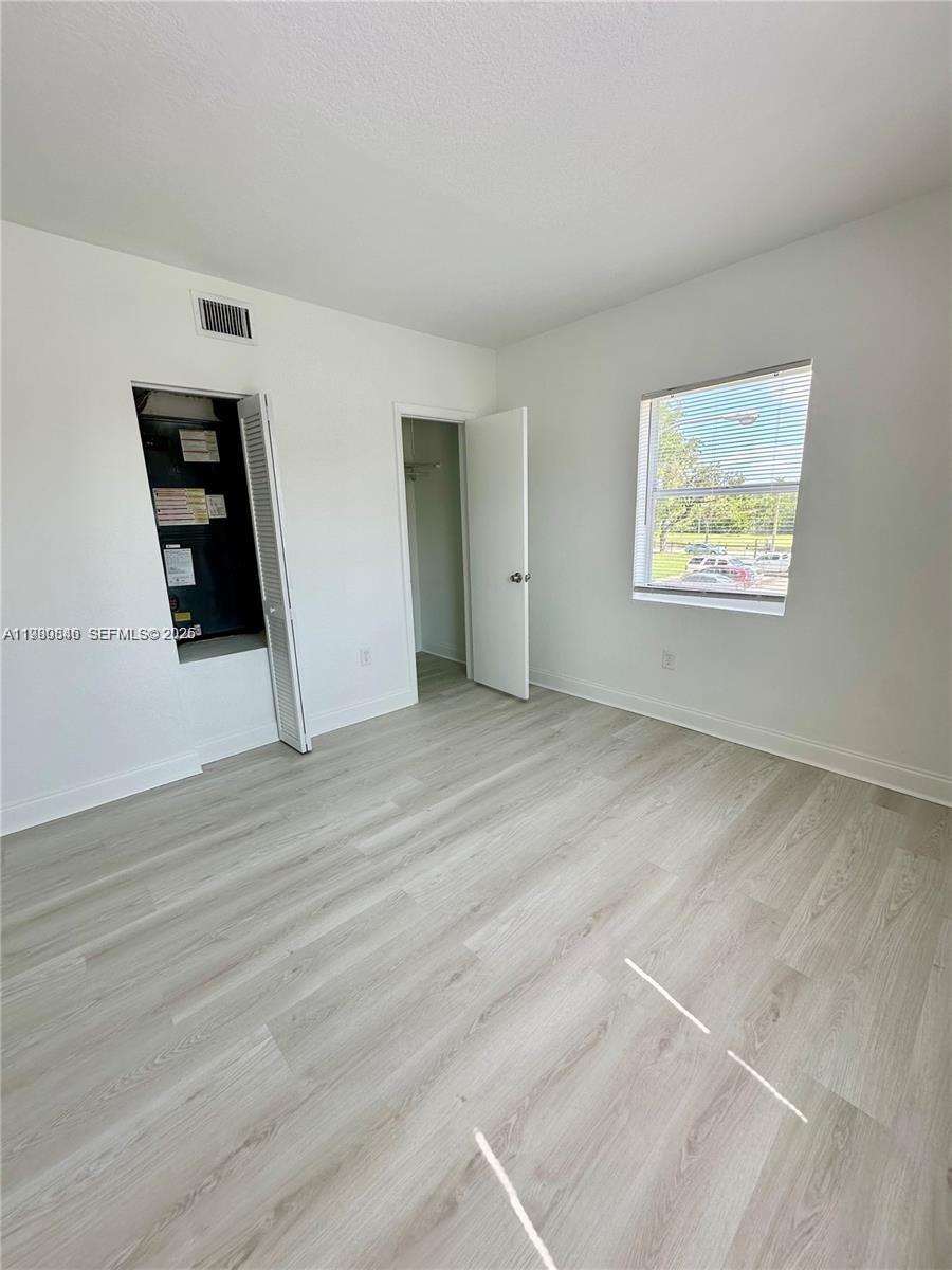 434 Northwest 85th Street Road, Unit 434 Miami, FL 33150 - Photo 12 of 31 a view of an empty room with wooden floor