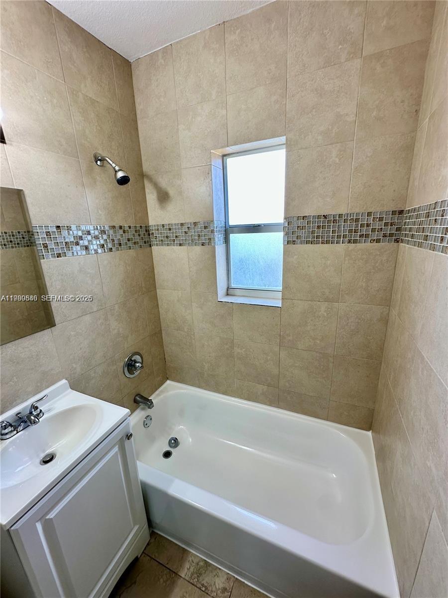 434 Northwest 85th Street Road, Unit 434 Miami, FL 33150 - Photo 22 of 31 a bath tub sitting next to a white sink