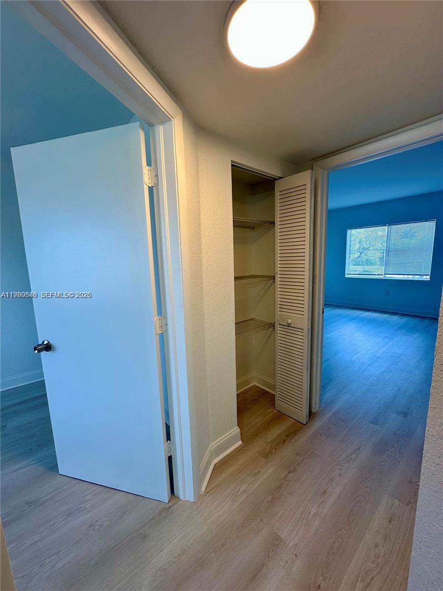 434 Northwest 85th Street Road, Unit 434 Miami, FL 33150 - Photo 23 of 31 an empty room with wooden floor and windows