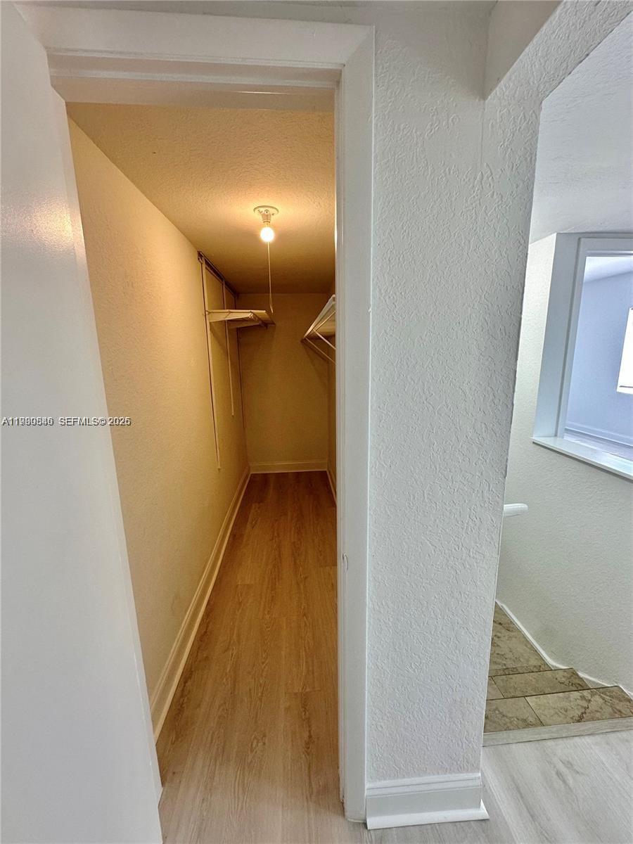 434 Northwest 85th Street Road, Unit 434 Miami, FL 33150 - Photo 24 of 31 a view of hallway with wooden floor