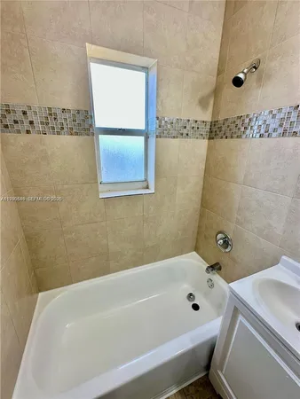 a bathroom with a bathtub and shower