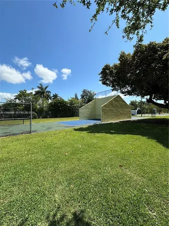 a view of yard with swimming pool and green space