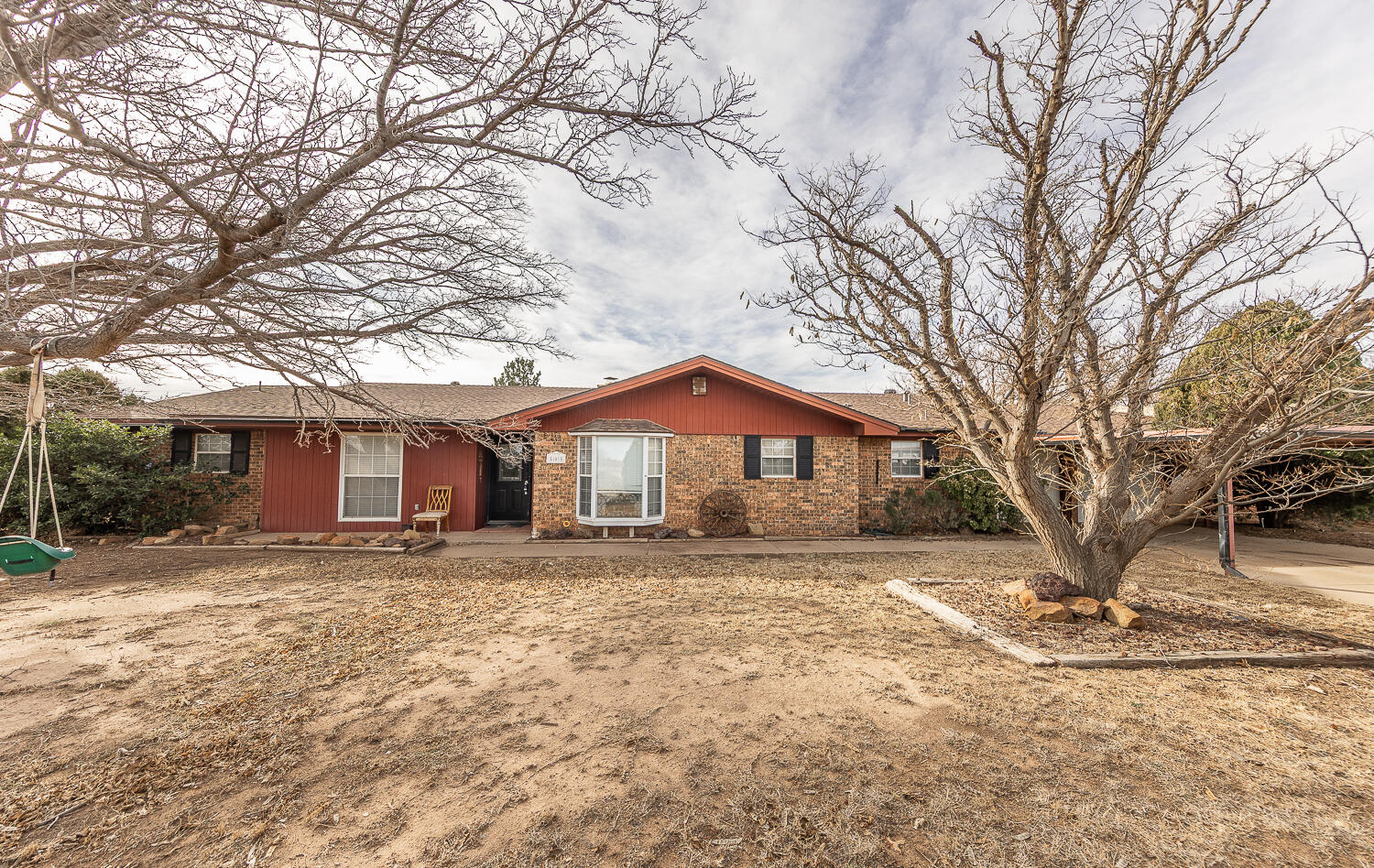 505 Owen Street Lubbock, TX 79403 - Photo 1 of 32 a white house that has a tree in front of it