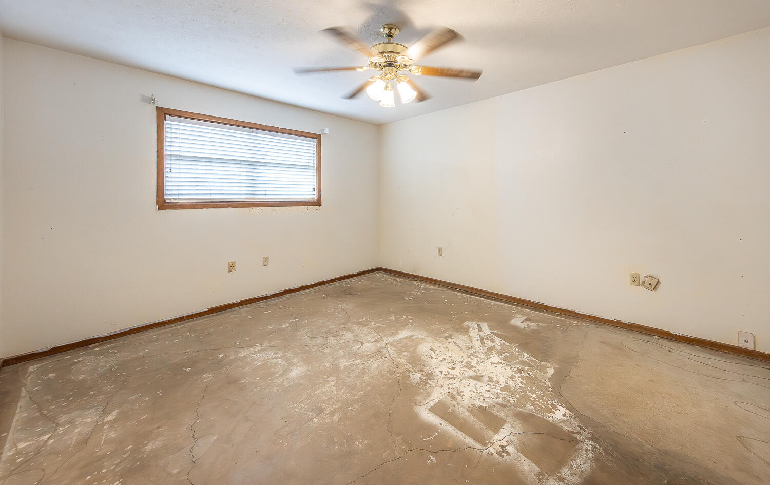 505 Owen Street Lubbock, TX 79403 - Photo 11 of 32 an empty room with a chandelier fan and windows