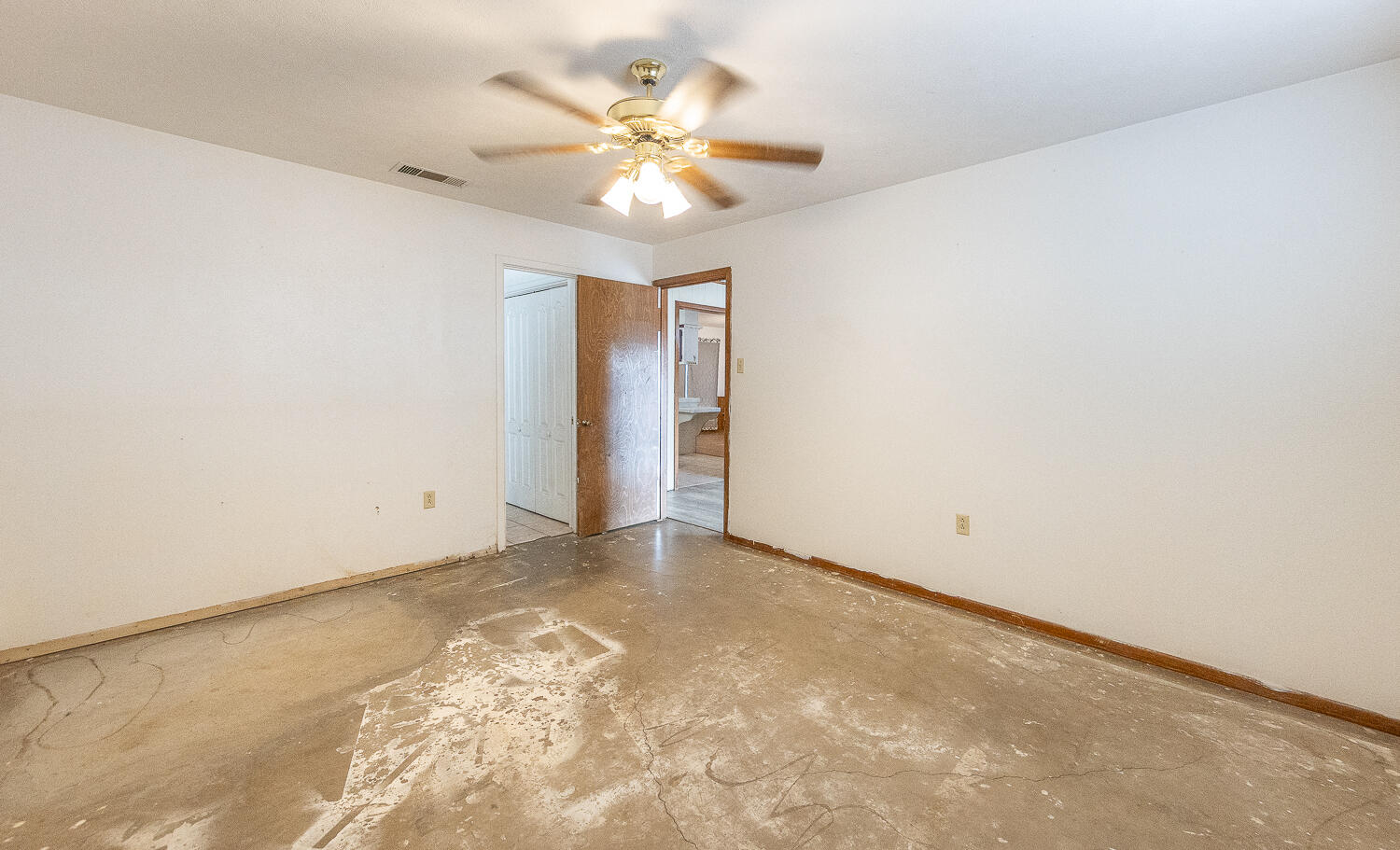 505 Owen Street Lubbock, TX 79403 - Photo 12 of 32 an empty room with a chandelier fan and windows
