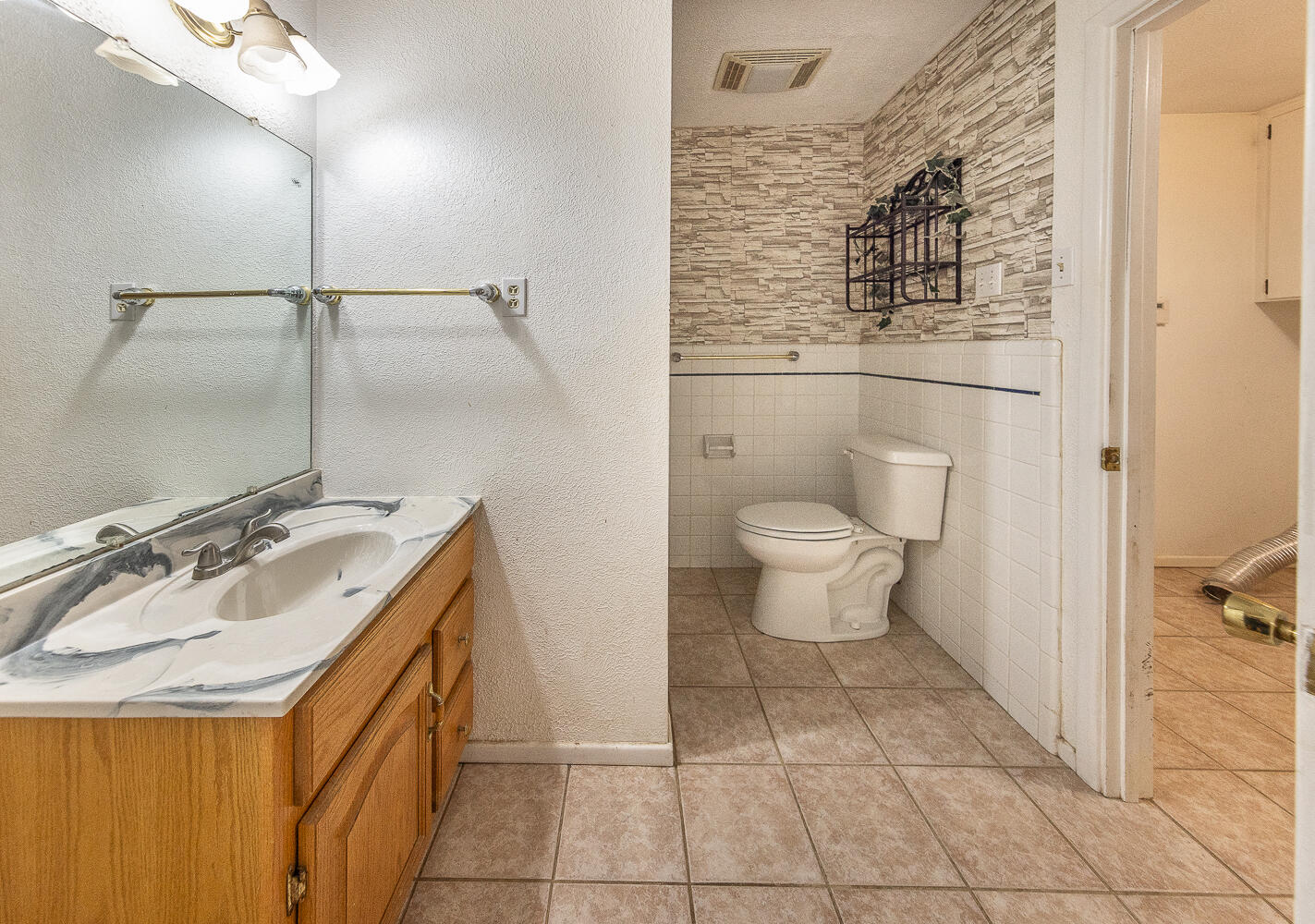 505 Owen Street Lubbock, TX 79403 - Photo 13 of 32 a bathroom with a sink toilet and shower