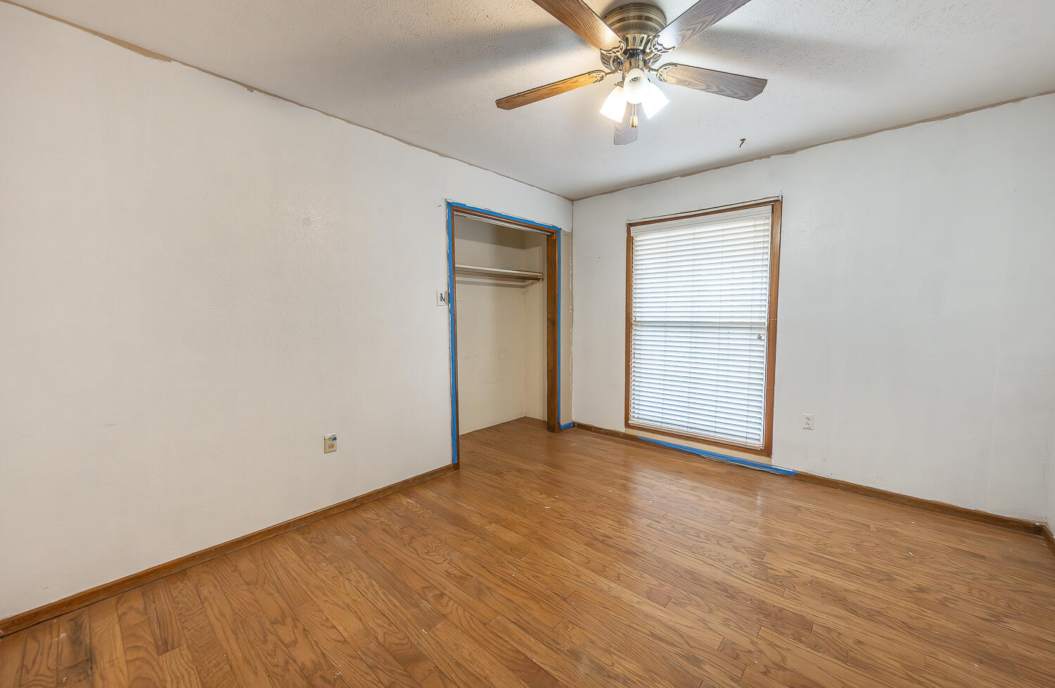 505 Owen Street Lubbock, TX 79403 - Photo 17 of 32 an empty room with a chandelier fan and windows
