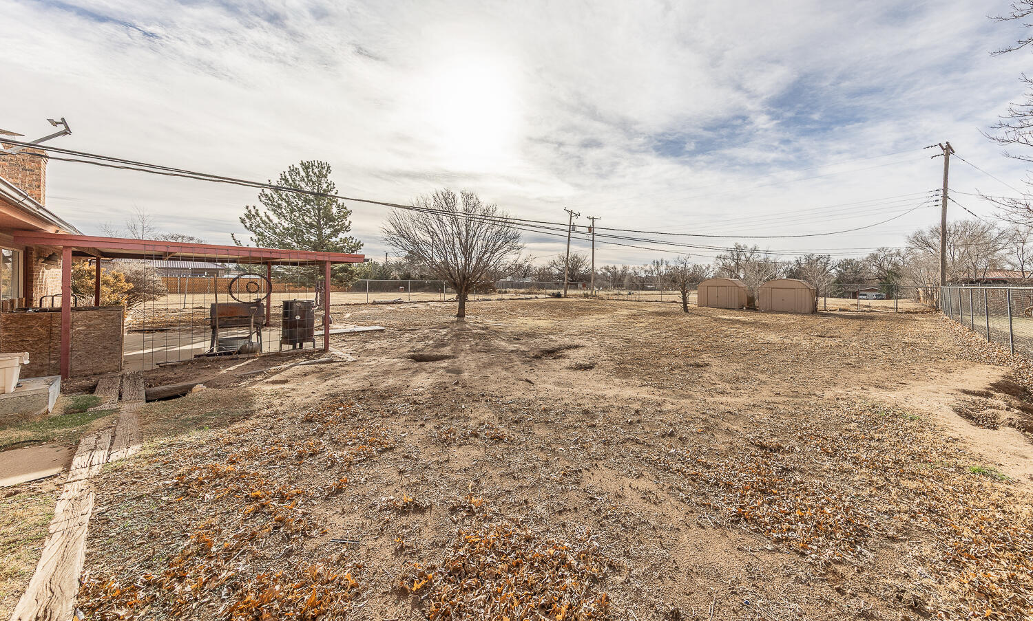 505 Owen Street Lubbock, TX 79403 - Photo 23 of 32 a view of a dry yard with wooden fence