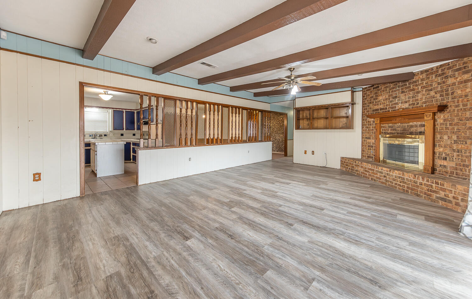 505 Owen Street Lubbock, TX 79403 - Photo 7 of 32 a view of empty room with wooden floor and fan