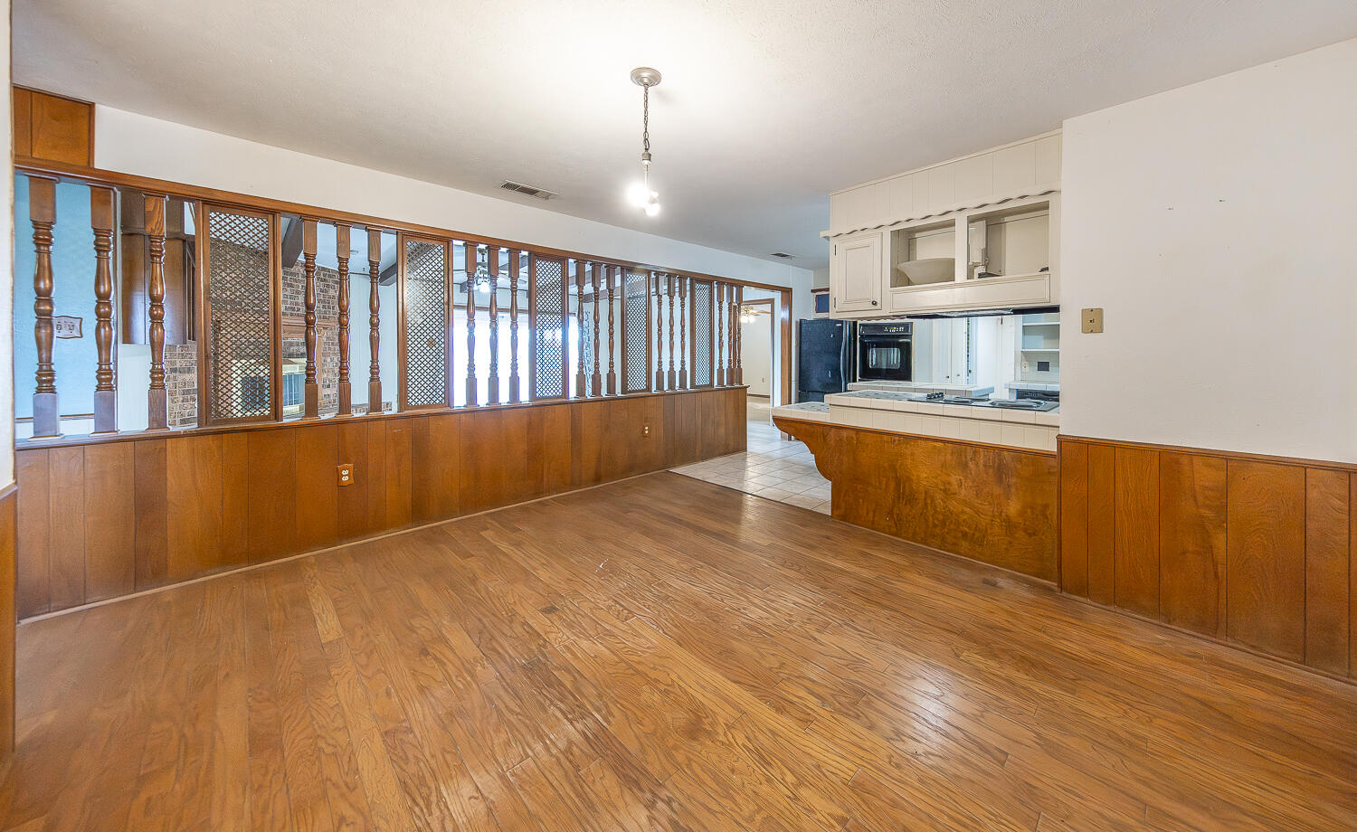 505 Owen Street Lubbock, TX 79403 - Photo 10 of 32 a view of a kitchen with wooden floor and electronic appliances