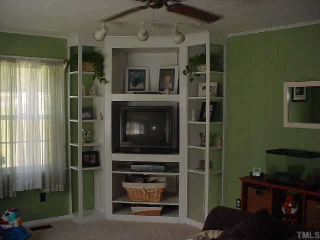 5501 Meadowbrook Road Raleigh, NC 27603 - Photo 3 of 9 a living room with a flat screen tv and a fireplace