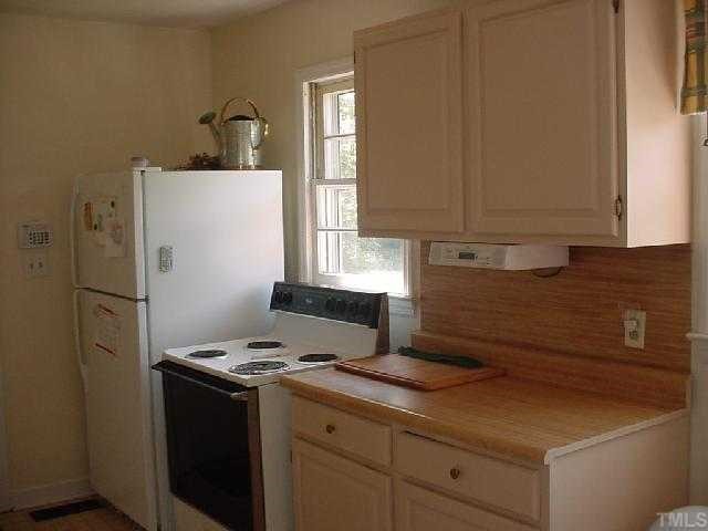 5501 Meadowbrook Road Raleigh, NC 27603 - Photo 4 of 9 a kitchen with a refrigerator sink and cabinets